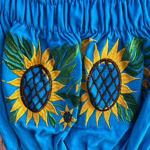 Blusa de girasol de hombro